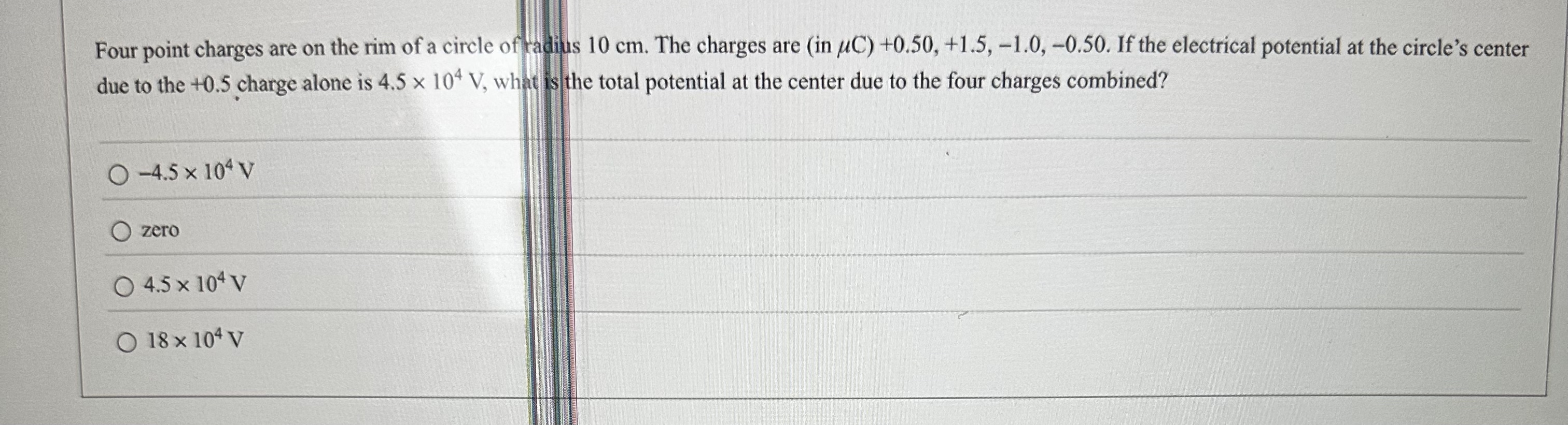 Four point charges are on the rim of a circle of