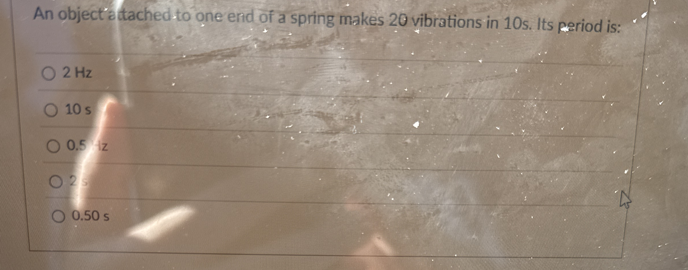 An object attached to one end of a spring makes 2