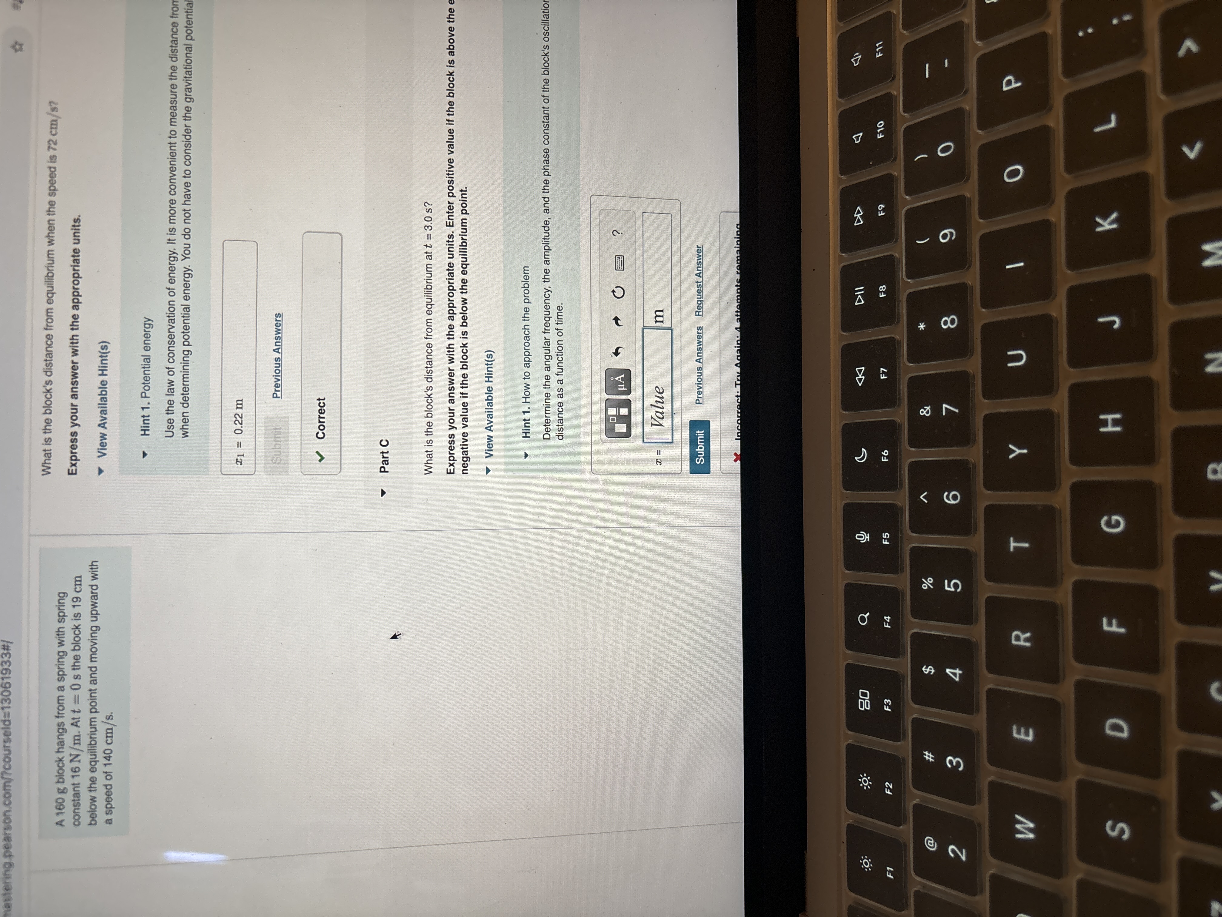 A 1 6 0 g block hangs from a spring with spring