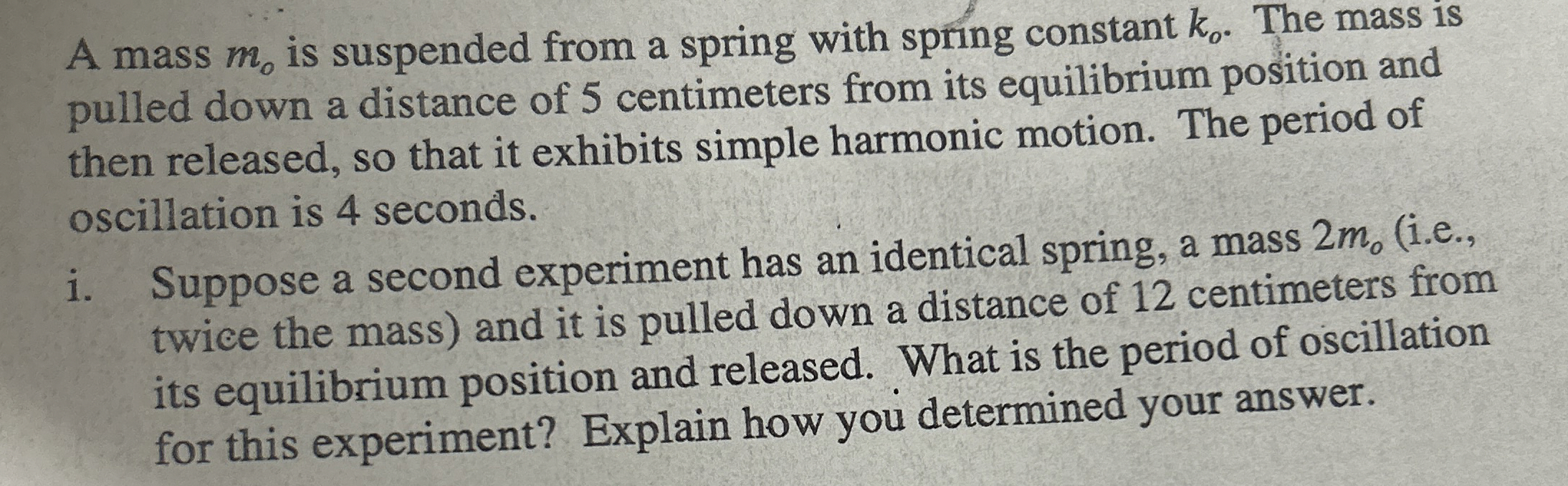 A mass m o is suspended from a spring with spring