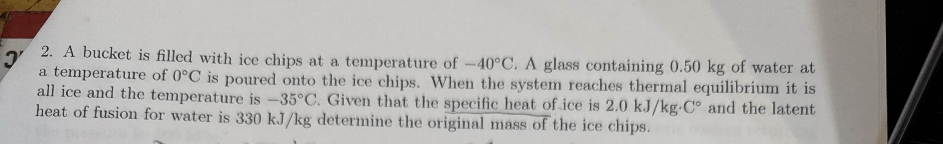 J 2 . A bucket is filled with ice chips at a