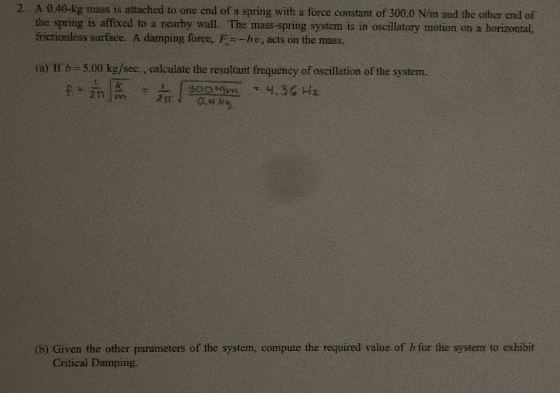 A 0 . 4 0 - k g mass is attached to one end of a
