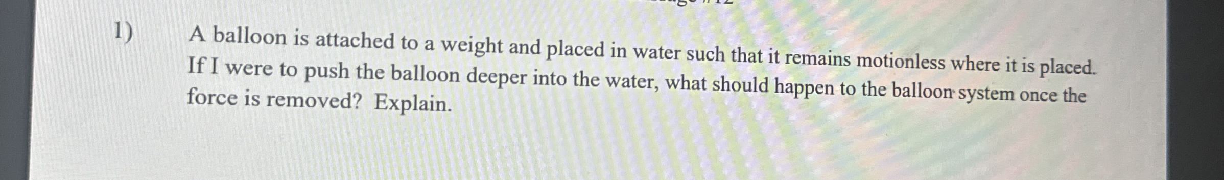 A balloon is attached to a weight and placed in