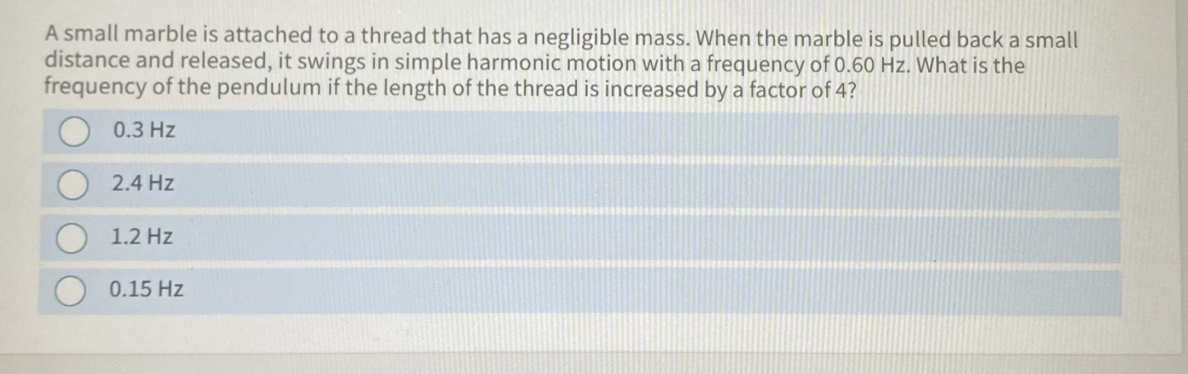 A small marble is attached to a thread that has a