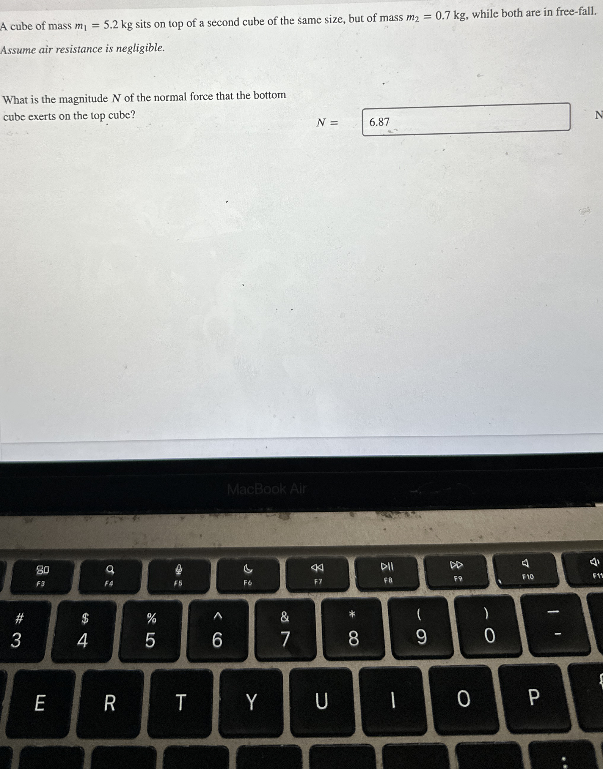 A cube of mass m 1 = 5 . 2 k g sits on top of a