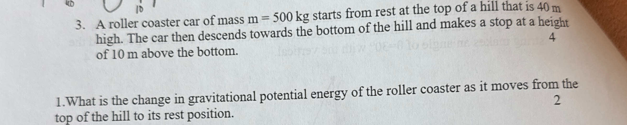 A roller coaster car of mass m = 5 0 0 k g starts