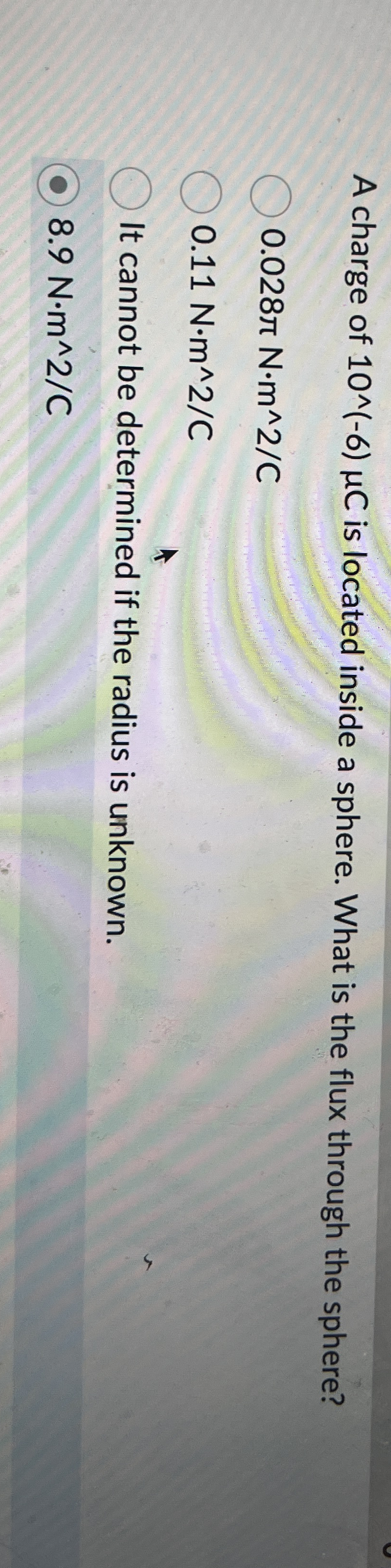 A charge of 1 0 - 6 C is located inside a sphere.