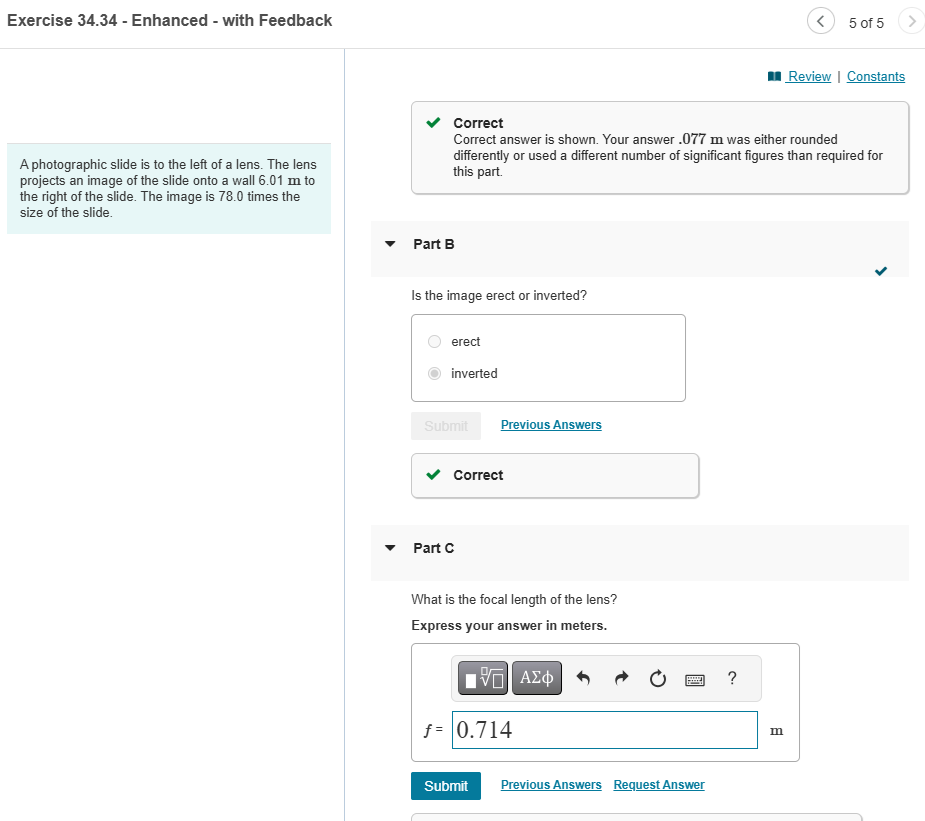 A photographic slide is to the left of a lens.