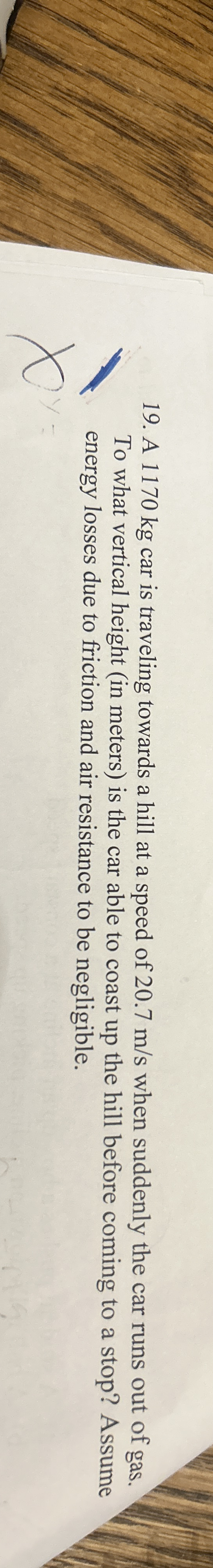 A 1 1 7 0 kg car is traveling towards a hill at a