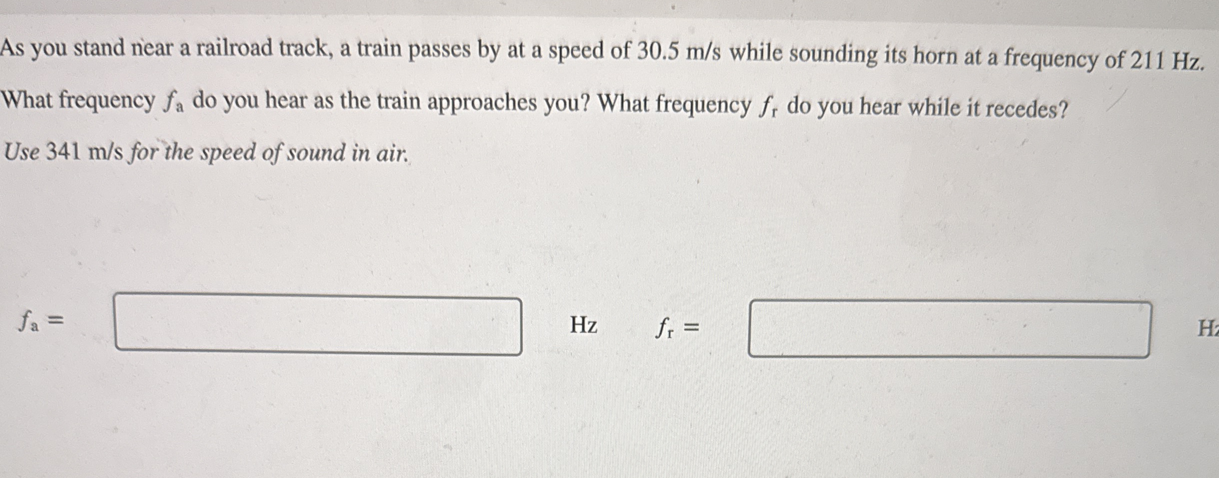 As you stand near a railroad track, a train