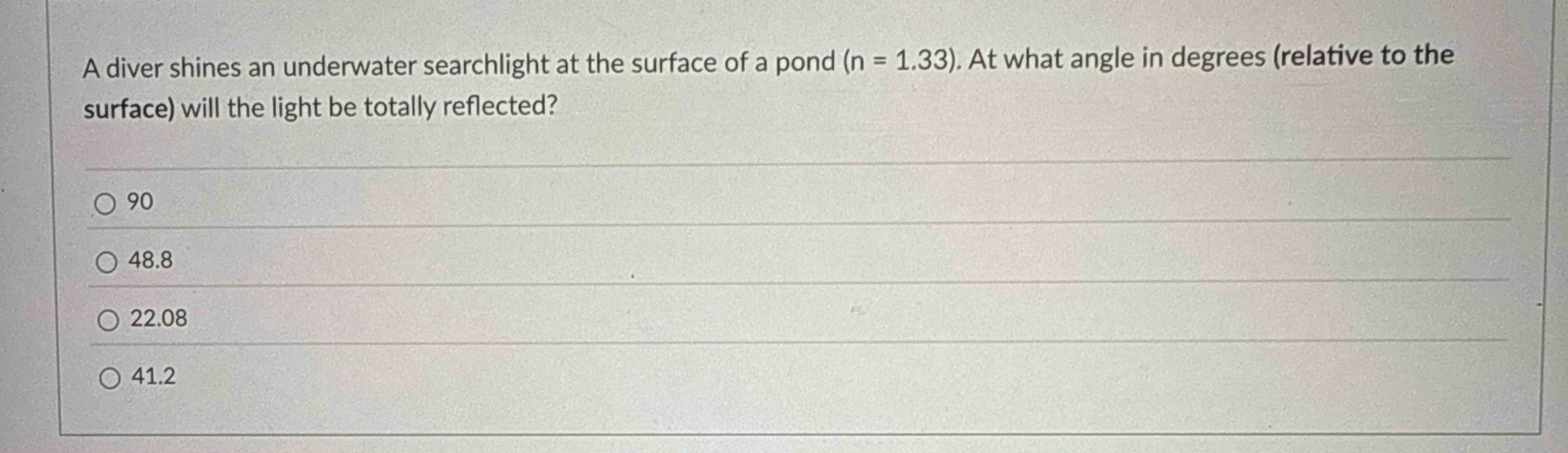 A diver shines an underwater searchlight at the