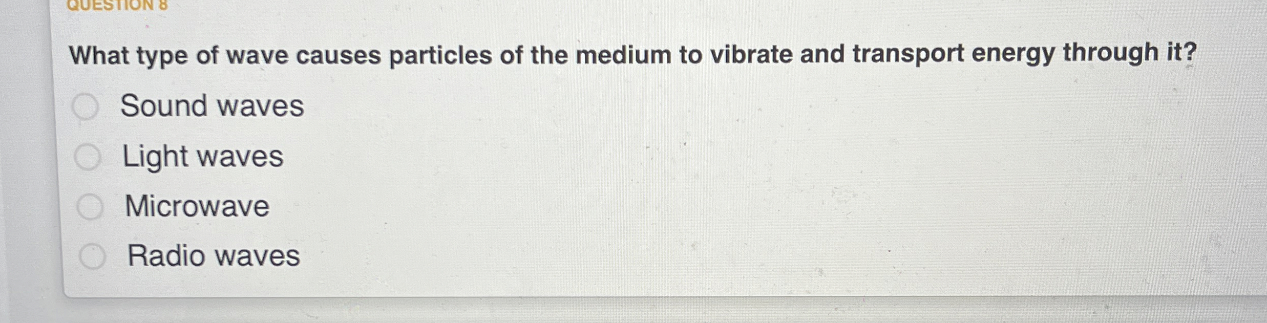 What type of wave causes particles of the medium