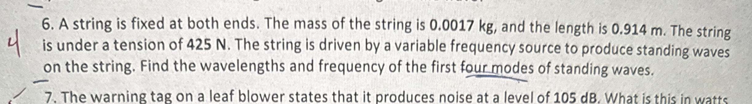 A string is fixed at both ends. The mass of the