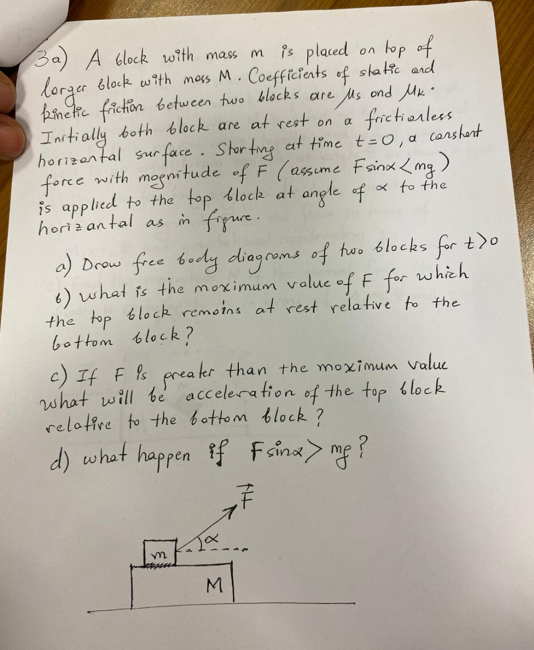 3 a ) A block with mass m is placed on top of