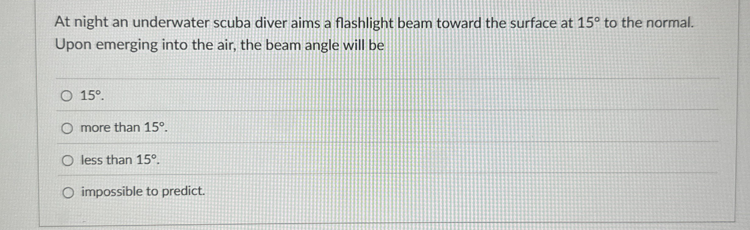 At night an underwater scuba diver aims a