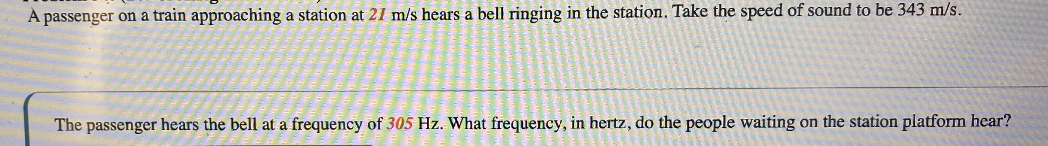 A passenger on a train approaching a station at 2