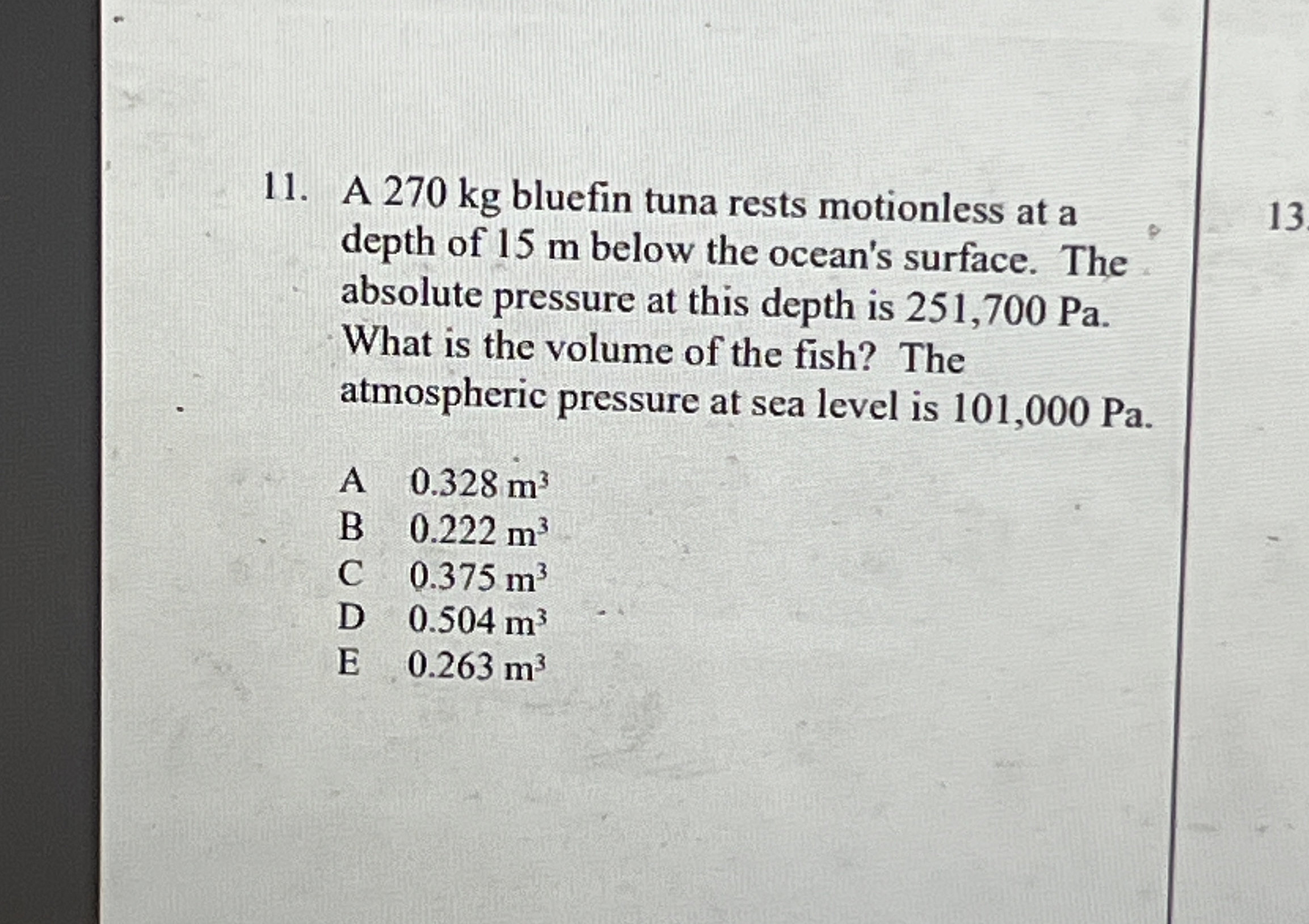 A 2 7 0 kg bluefin tuna rests motionless at a