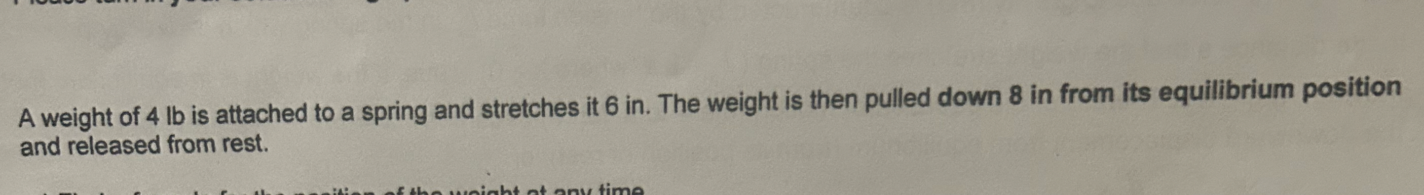 A weight of 4 lb is attached to a spring and
