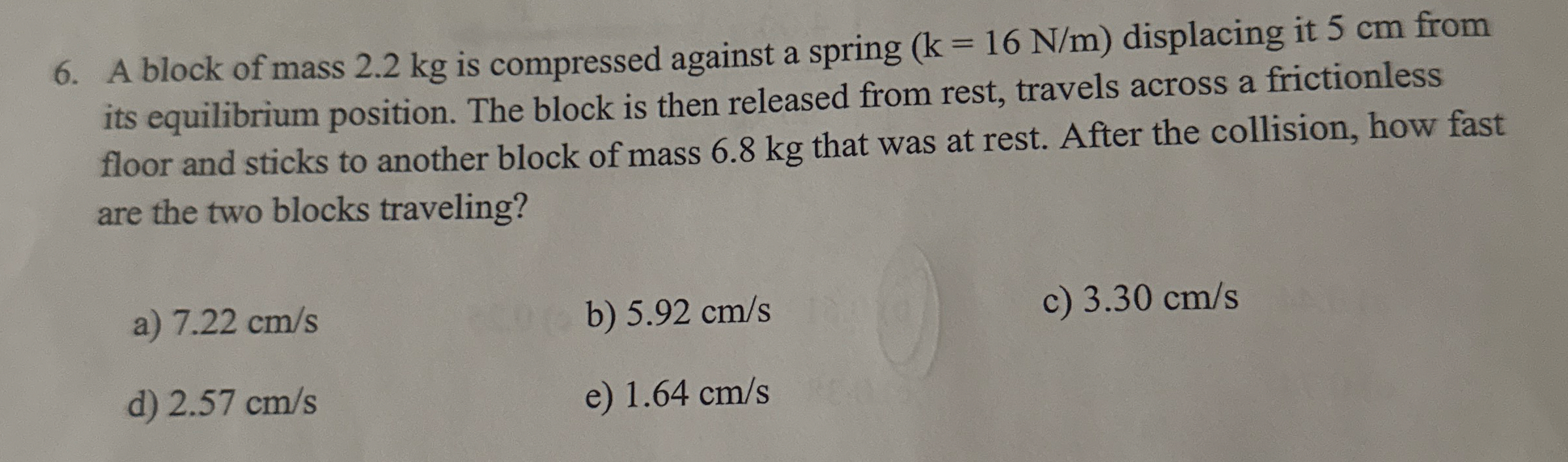 A block of mass 2 . 2 kg is compressed against a