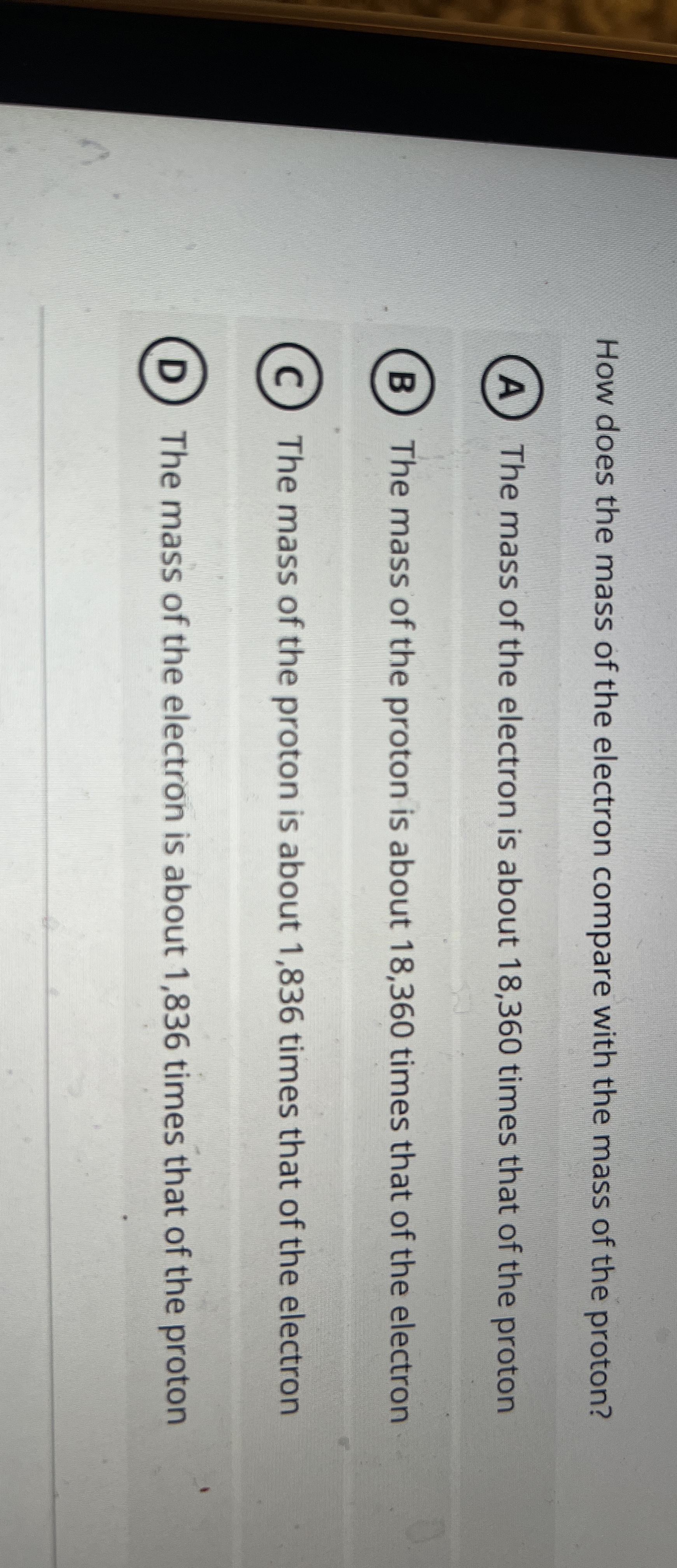 How does the mass of the electron compare with