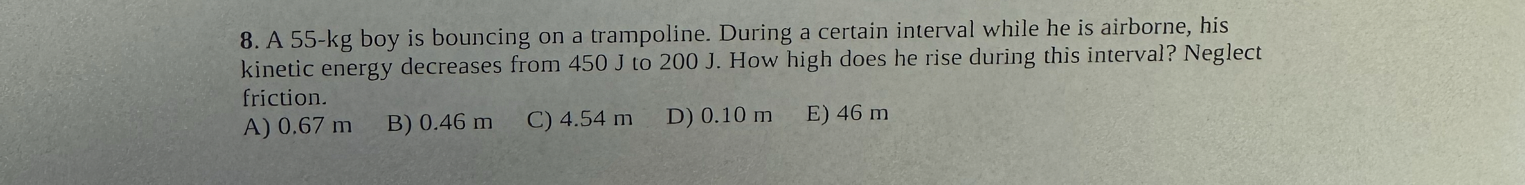 A 5 5 - k g boy is bouncing on a trampoline.
