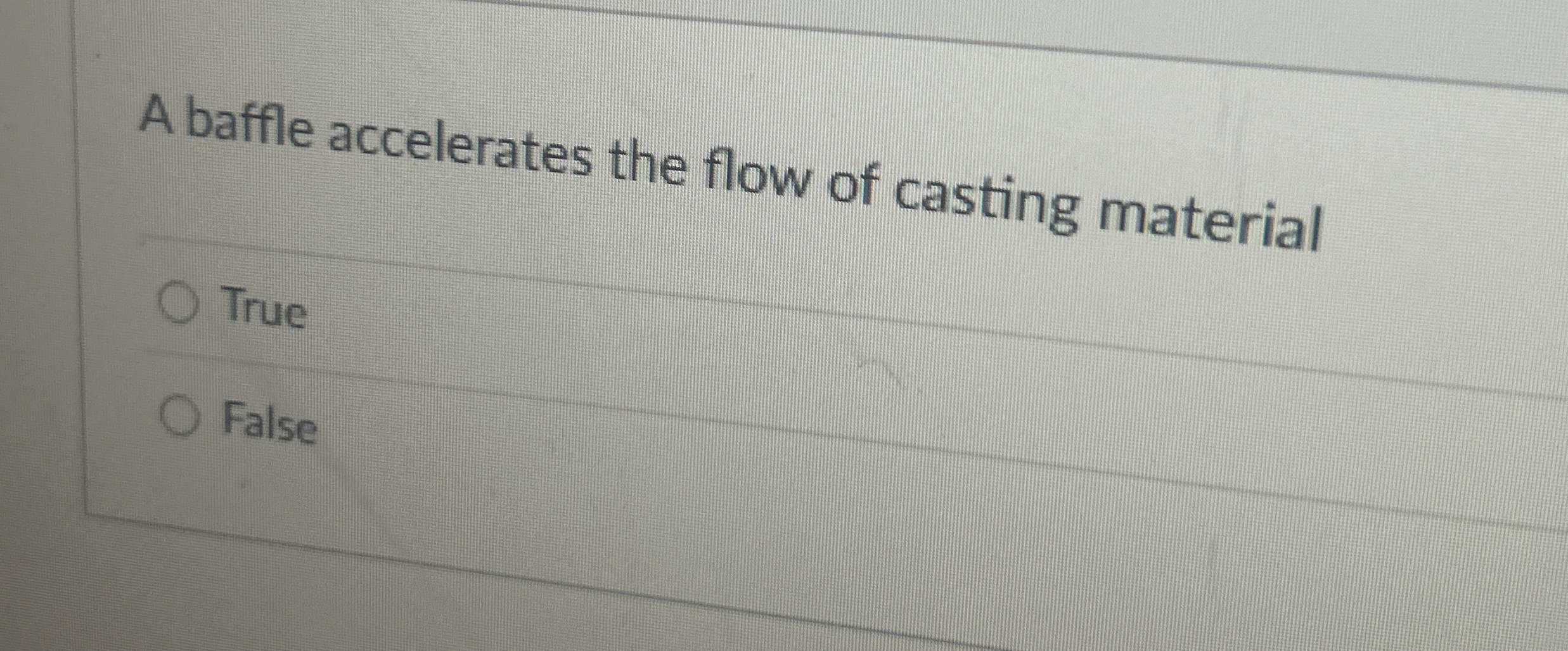 A baffle accelerates the flow of casting material