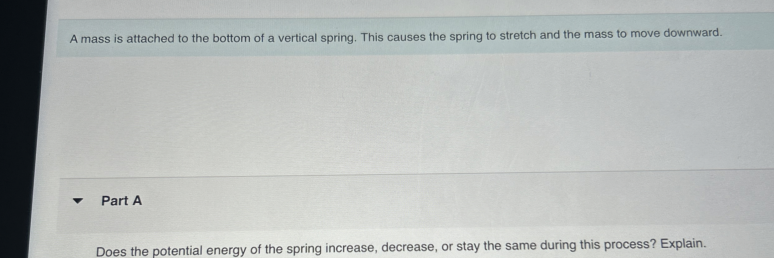 A mass is attached to the bottom of a vertical