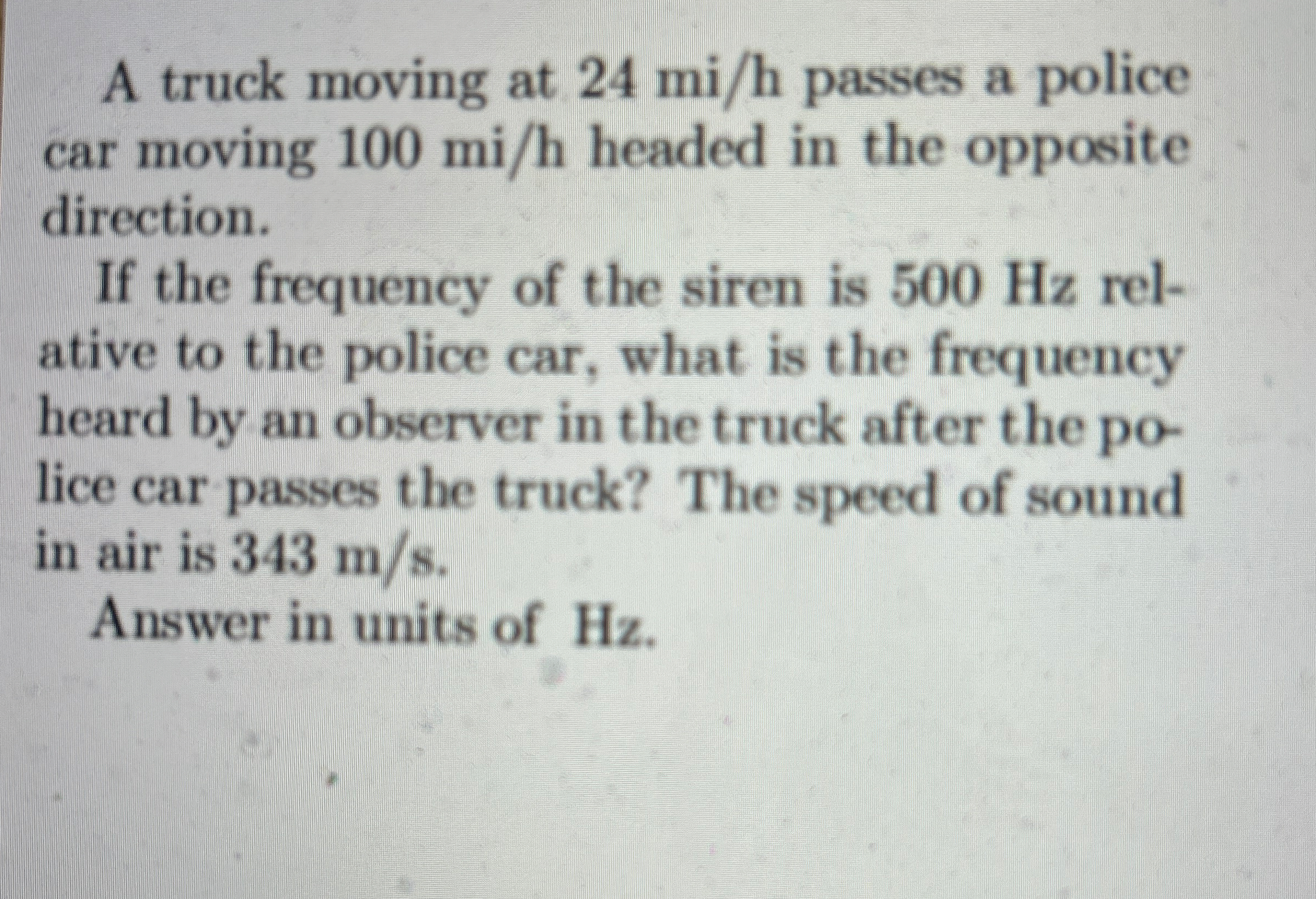 A truck moving at 2 4 m i h passes a police car