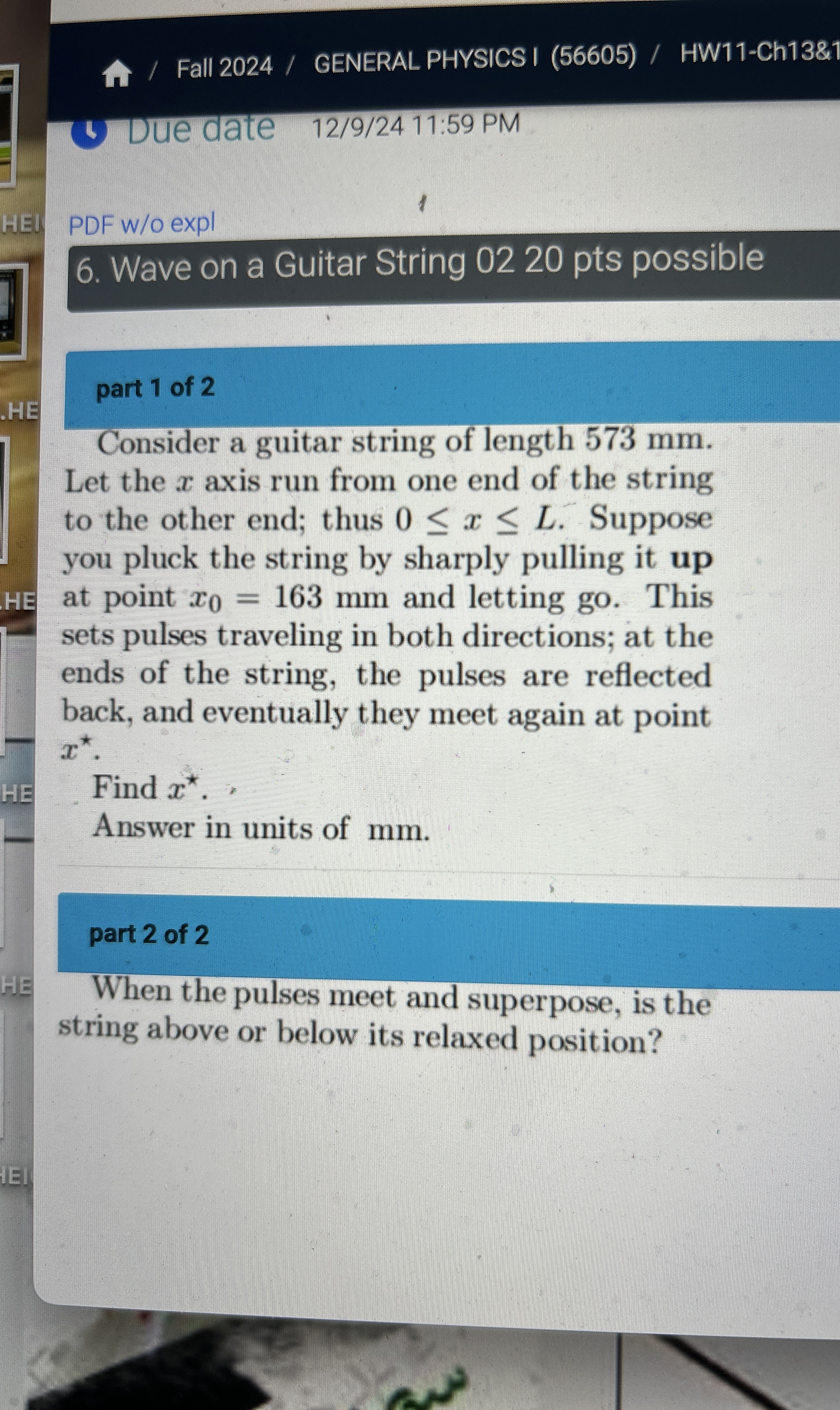 An alert physics student stands beside thetracks