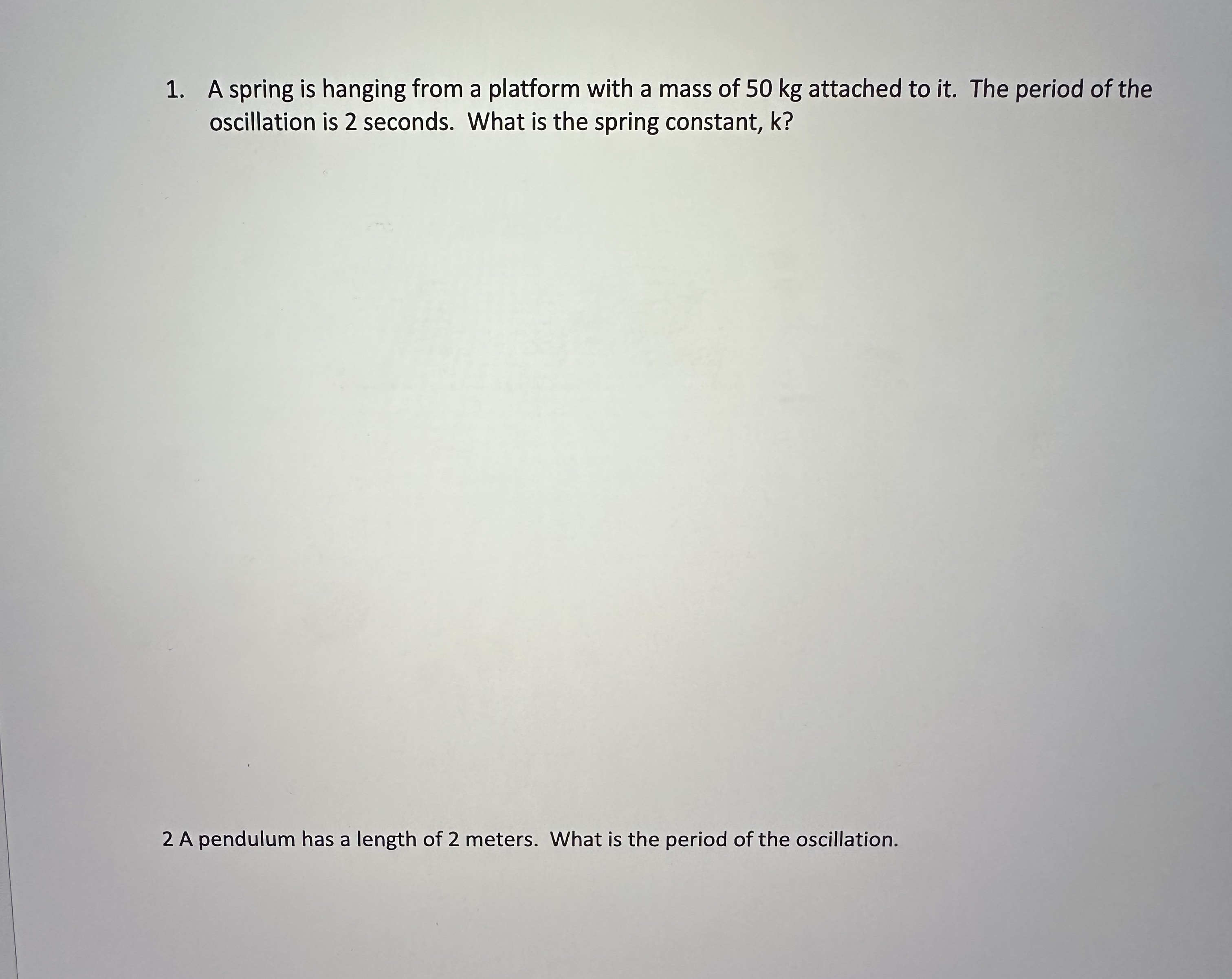 1 . A spring is hanging from a platform with a