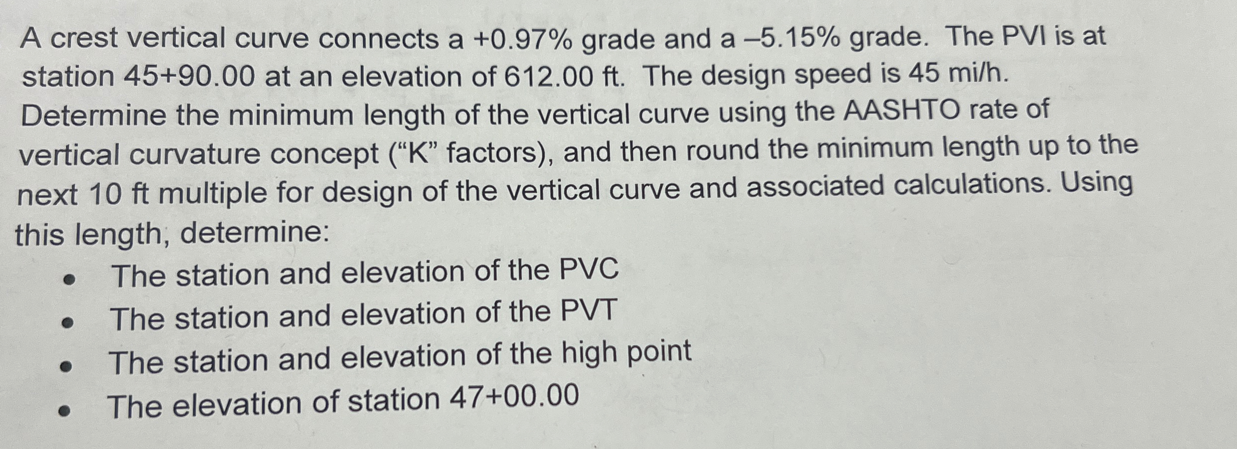 A crest vertical curve connects a + 0 . 9 7 %