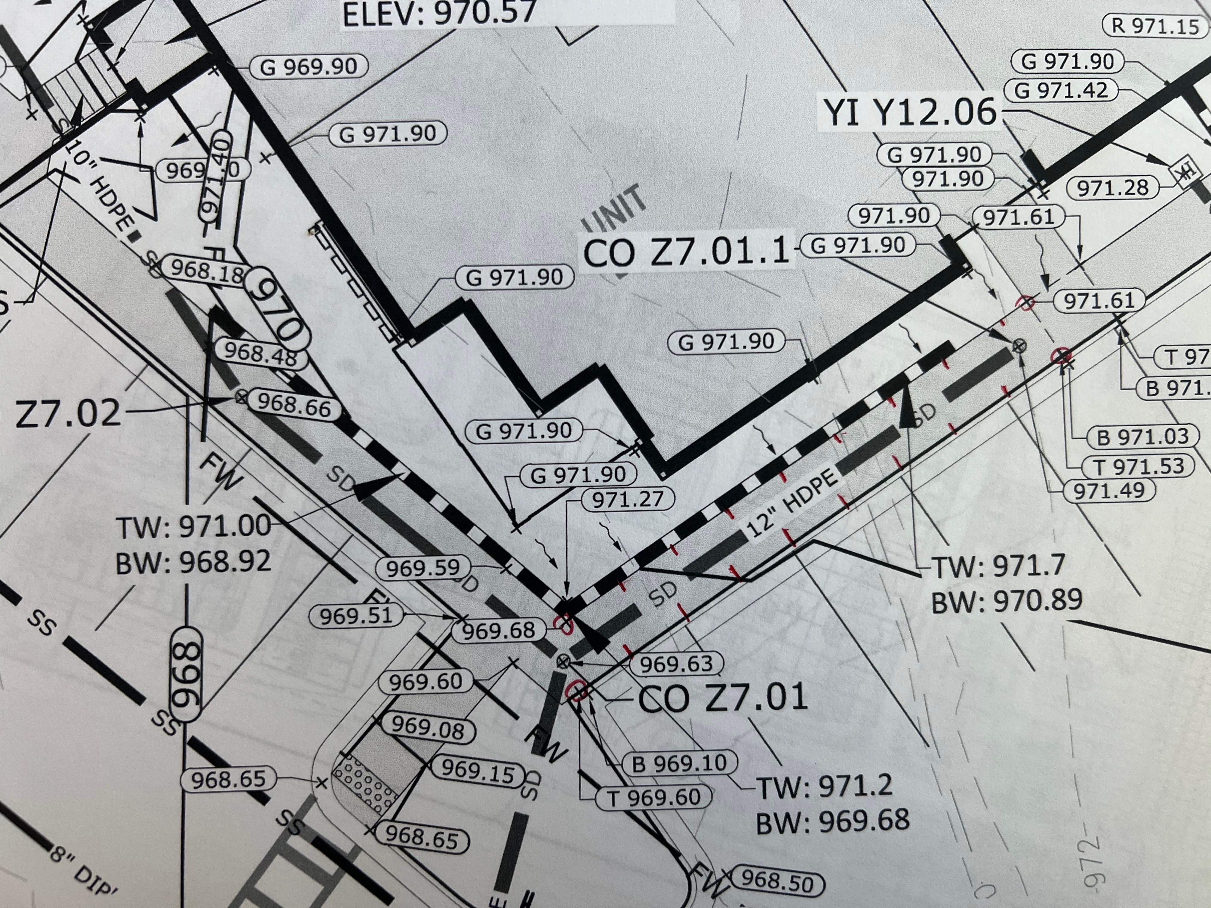 Find spot elevation for the side walk red marks,