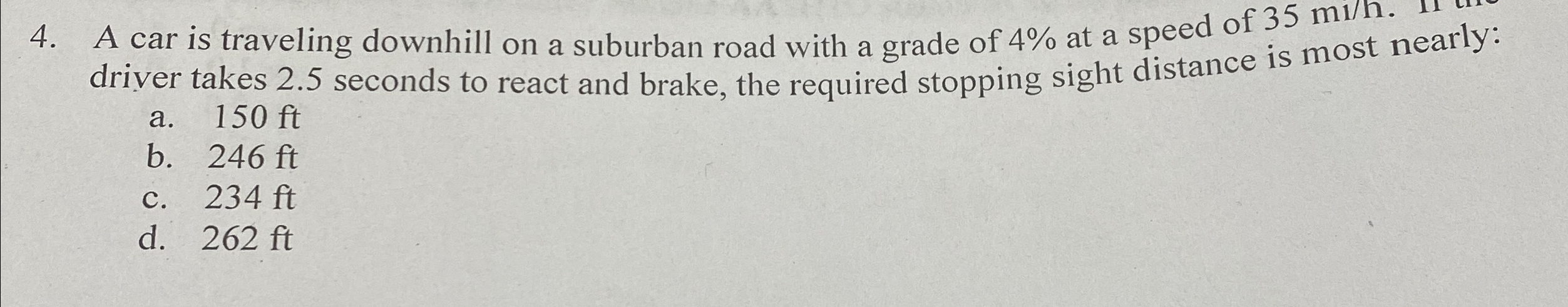 A car is traveling downhill on a suburban road