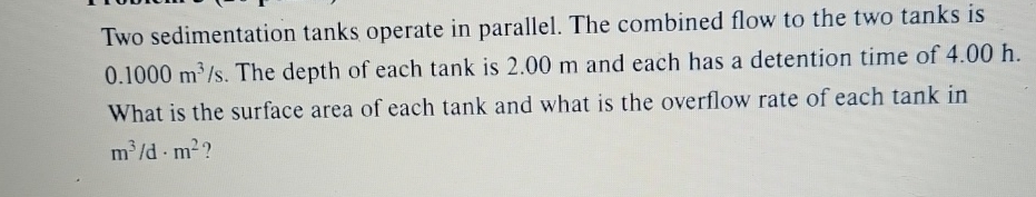 Two sedimentation tanks operate in parallel. The