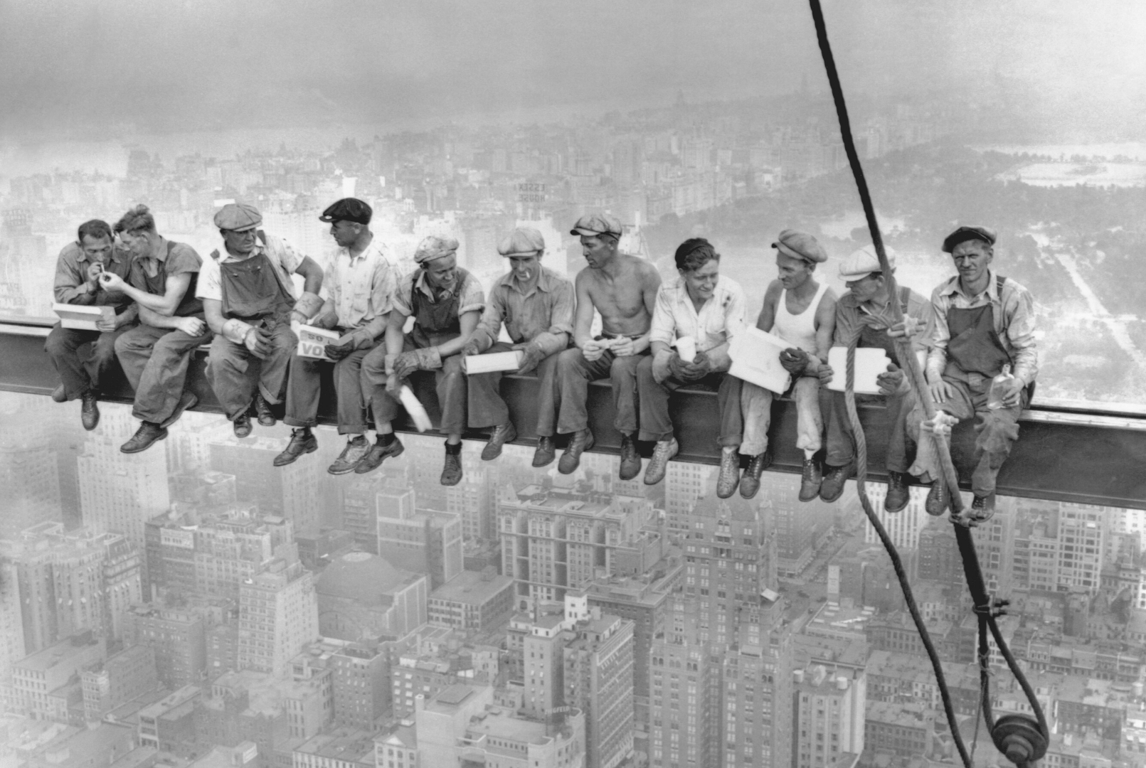 The fig. shows eleven ironworkers sitting on a