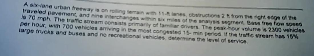 A six - lane urban freeway is on roling terrain