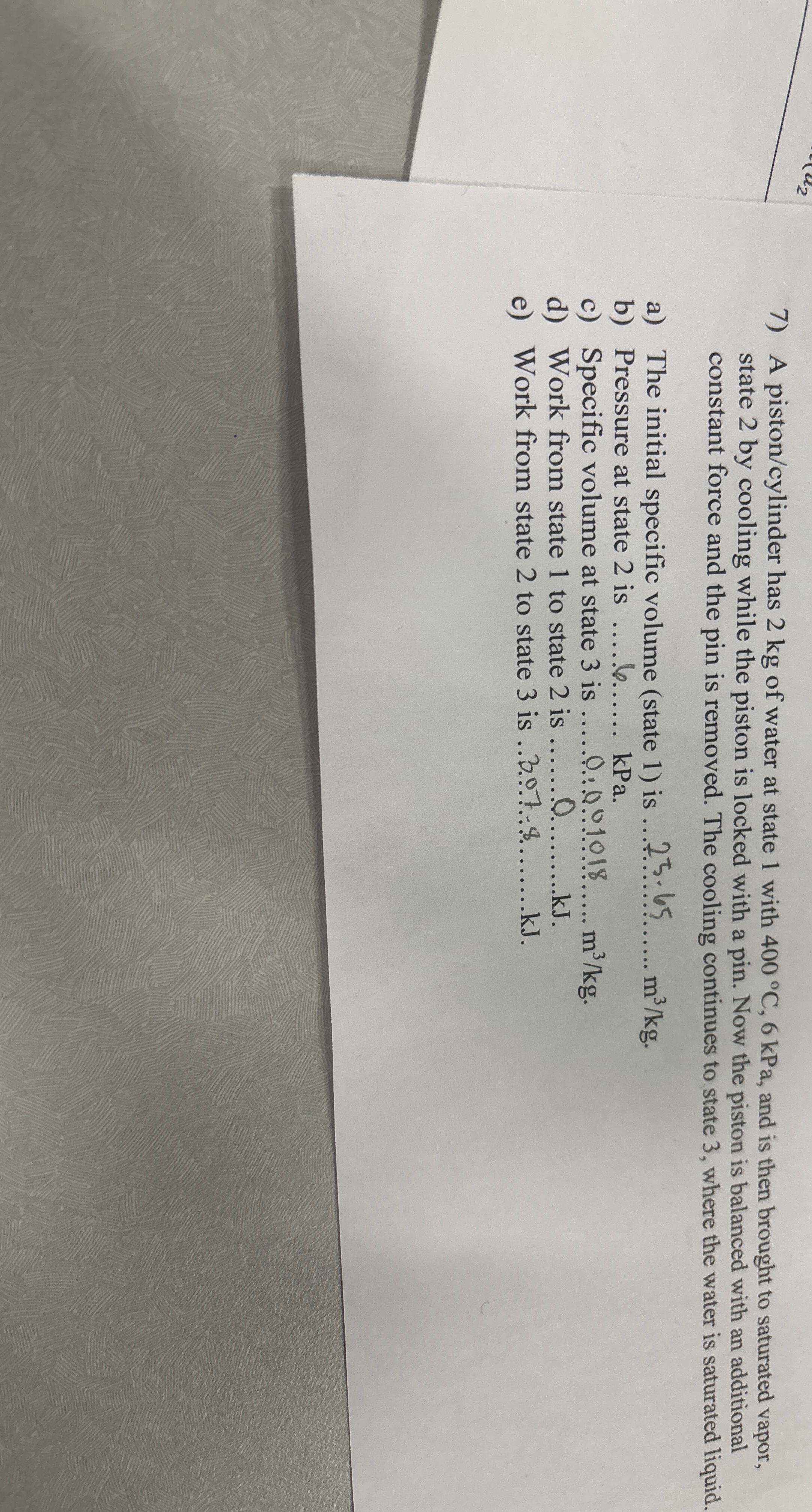 A piston / cylinder has 2 kg of water at state 1
