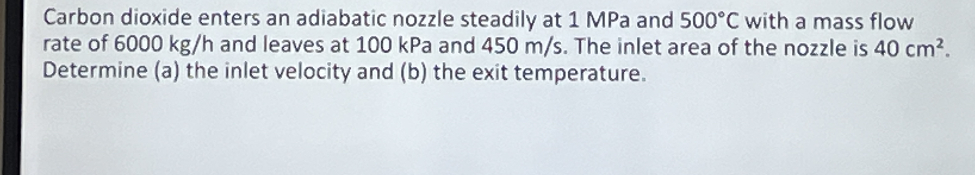 Carbon dioxide enters an adiabatic nozzle