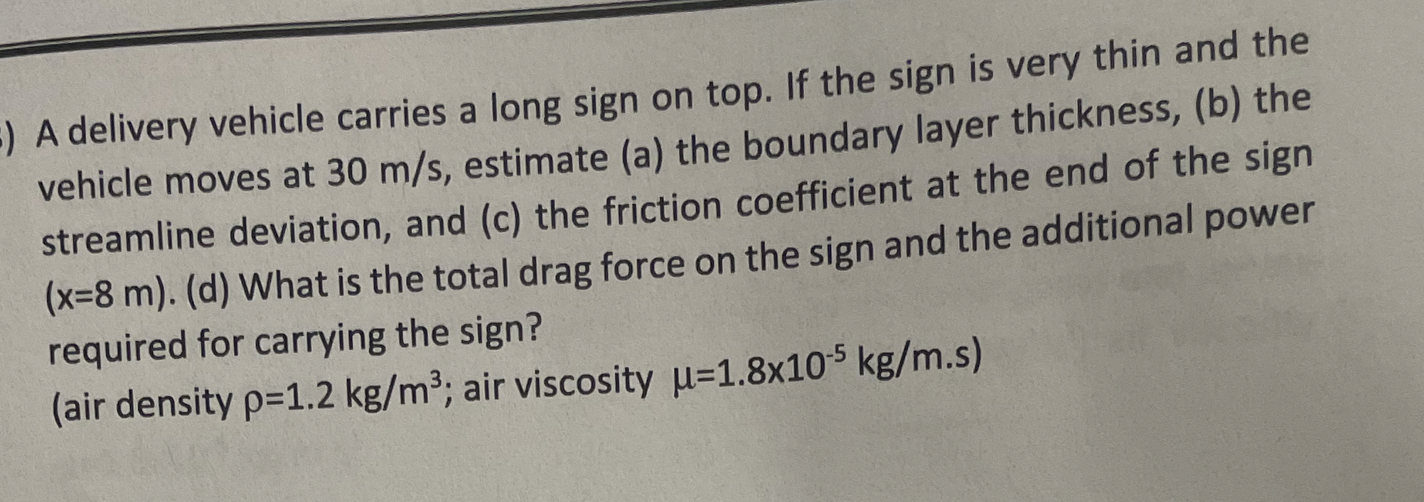 A delivery vehicle carries a long sign on top. If