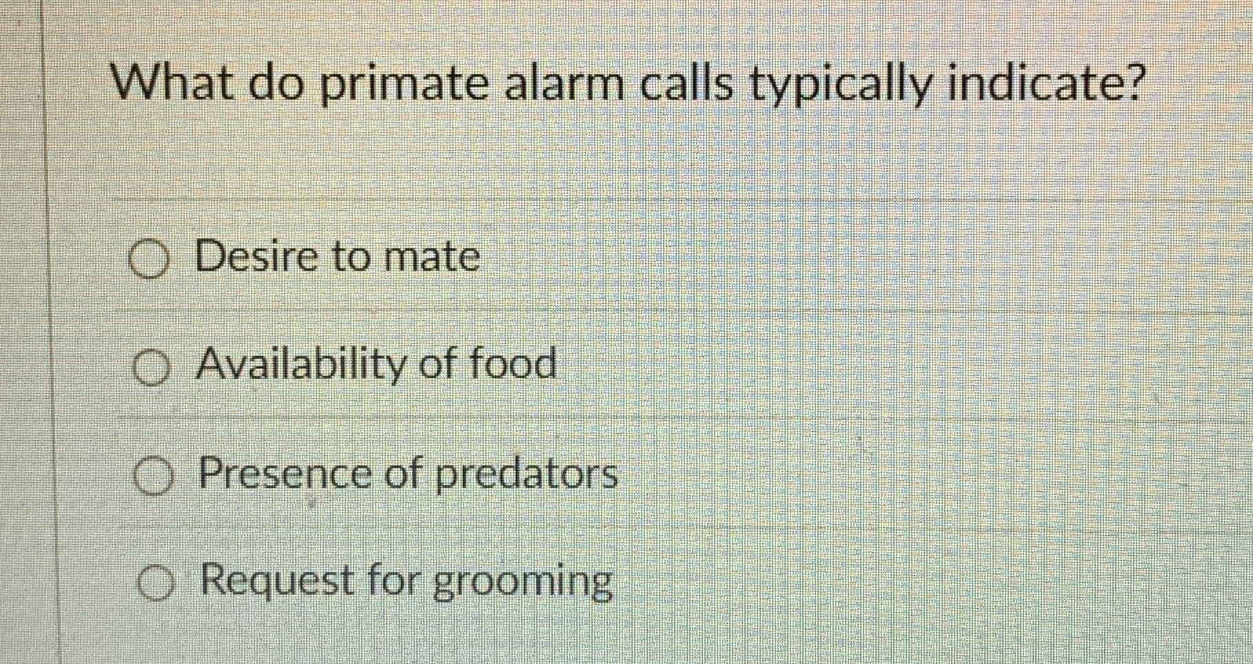 What do primate alarm calls typically indicate?