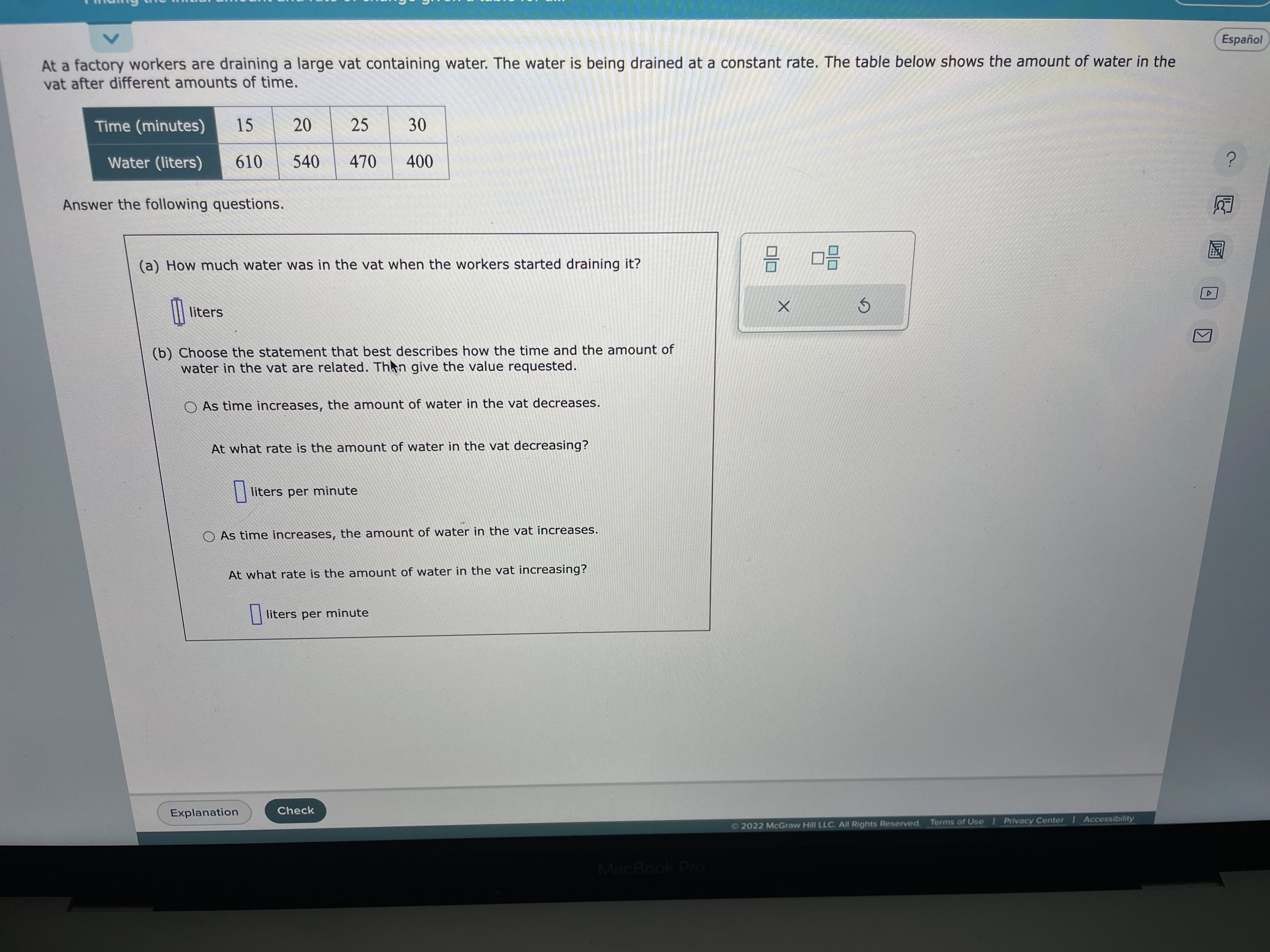 Espanol At a factory workers are draining a large