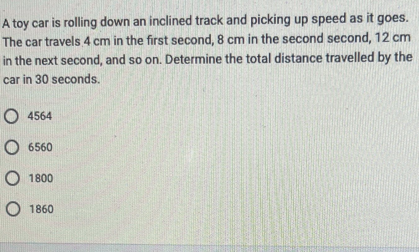 A toy car is rolling down an inclined track and