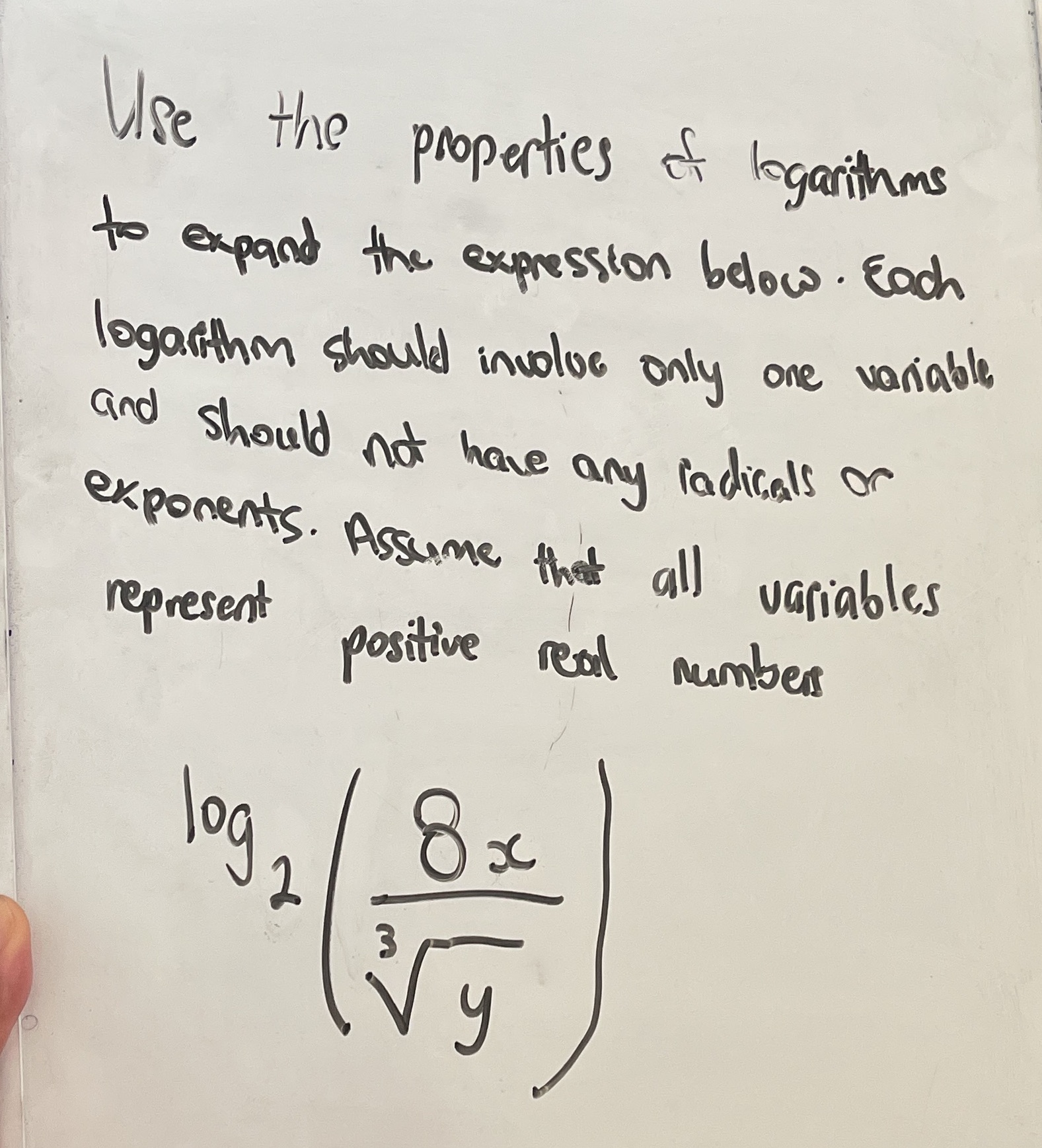 Use the properties of logarithms to expand the