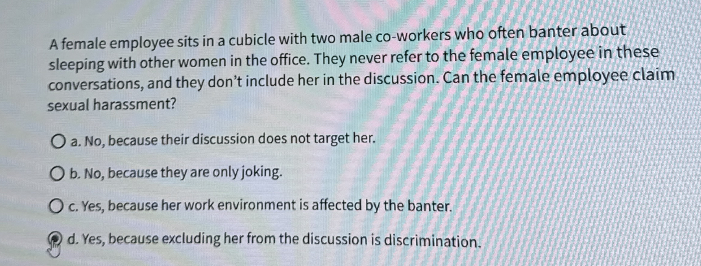 A female employee sits in a cubicle with two male