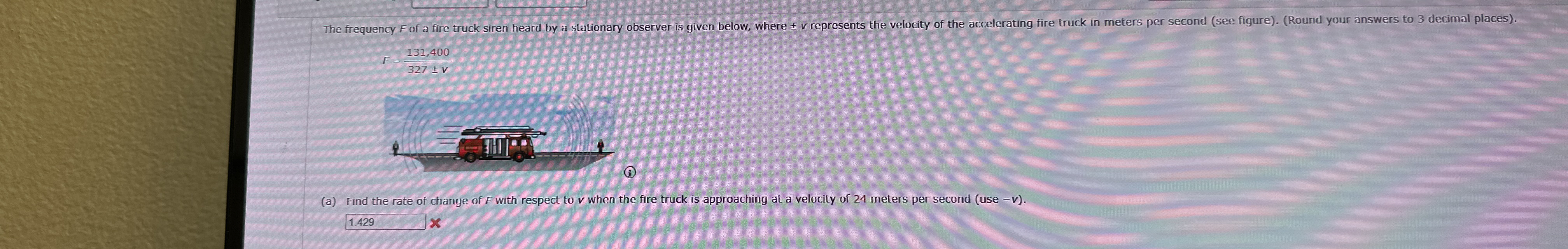 The frequency F of a fire truck siren heard by a
