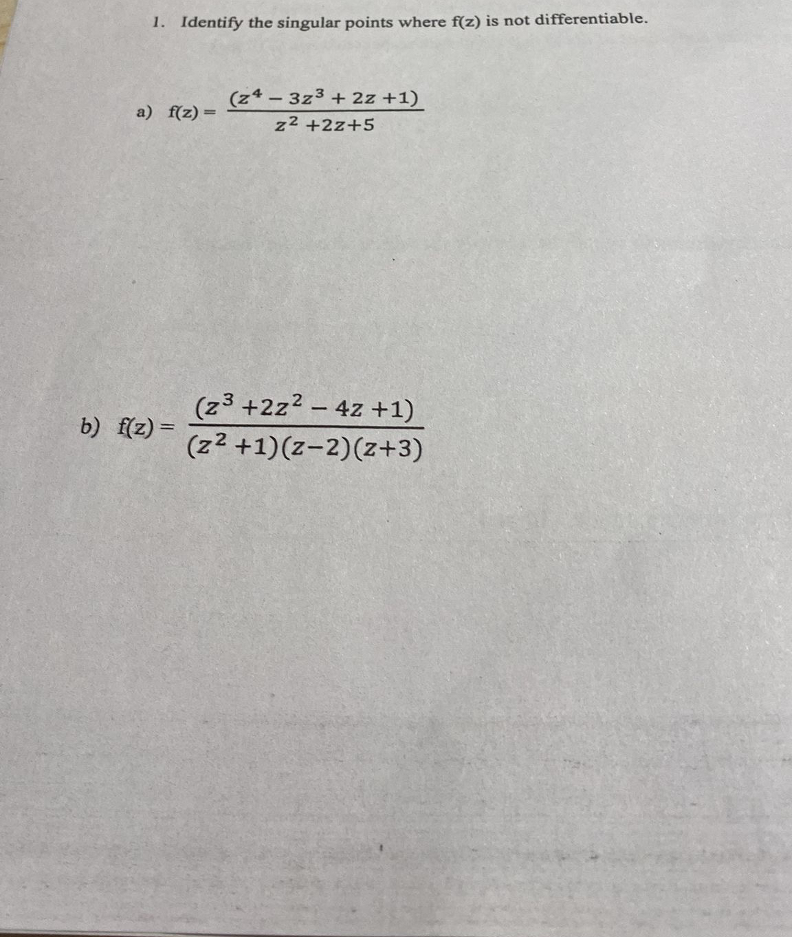 Identify the singular points where f ( z ) is not
