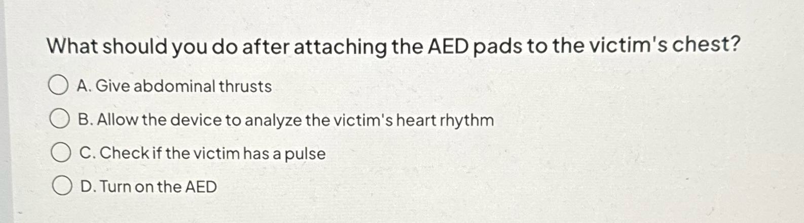 What should you do after attaching the AED pads