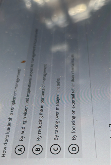 How does leadership complement managemene? By