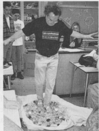 The photo shows physics instructor Marshall Ellenstein walking barefoot on