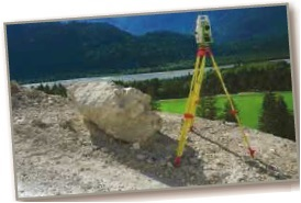 From the top of a mountain road, a surveyor takes